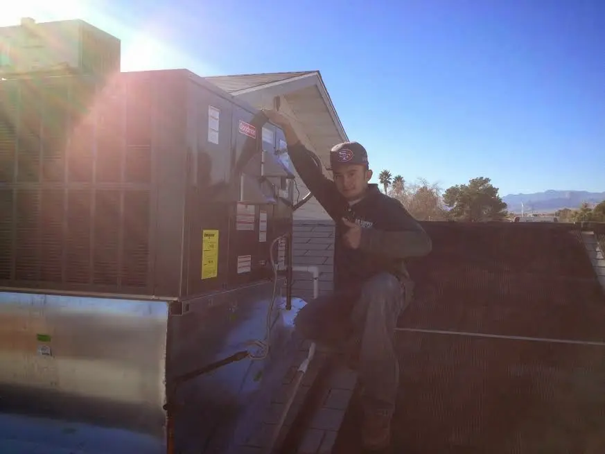 HVAC technician performing AC Tune-Up on a rooftop unit in East Coventry